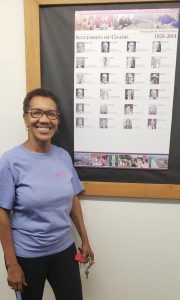 Dr Jackson next to poster of past Chairs